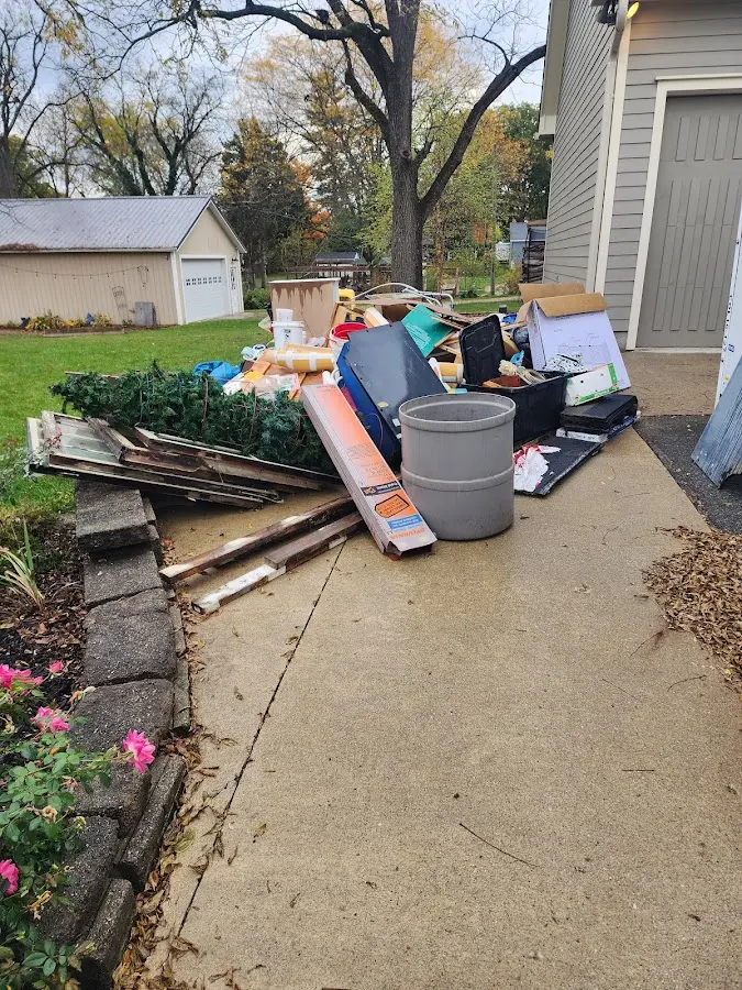 Dumpster being loaded with debris for Roofing Dumpster Rental in Champion Heights